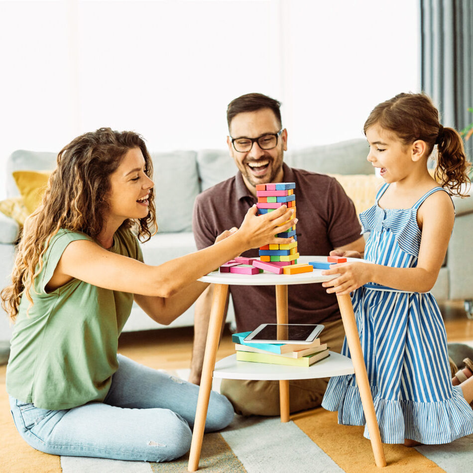 Family having fun playing board games in living room at home